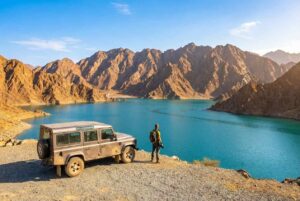 SUV parked at scenic viewpoint overlooking Hatta Dam turquoise 
